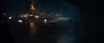 Movie still from “Edge of Tomorrow” (2014), directed by Doug Liman – An image of a fire in a city at night time; Extreme Wide shot, High angle