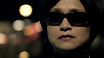 Movie still from “Sherlock” (2010), created by Steven Moffat – A person wearing sunglasses; Close Up shot, Low angle