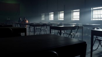 Movie still from “Sherlock” (2010), created by Steven Moffat – A man sitting at a table in a room; Extreme Wide shot, High angle