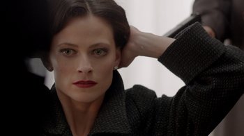 Movie still from “Sherlock” (2010), created by Steven Moffat – A person wearing a jacket; Close Up shot, Over the shoulder angle