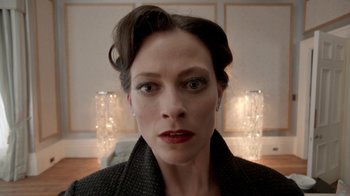 Movie still from “Sherlock” (2010), created by Steven Moffat – A person wearing a black jacket; Close Up shot, Low angle