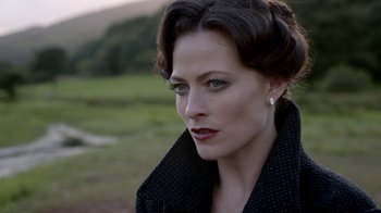 Movie still from “Sherlock” (2010), created by Steven Moffat – A person wearing a black jacket; Close Up shot, Over the shoulder angle