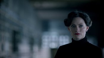 Movie still from “Sherlock” (2010), created by Steven Moffat – A person wearing a black shirt; Close Up shot, Over the shoulder angle