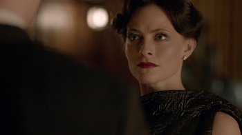 Movie still from “Sherlock” (2010), created by Steven Moffat – A person wearing a black dress; Close Up shot, Over the shoulder angle