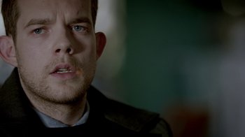 Movie still from “Sherlock” (2010), created by Steven Moffat – A man's face in a dark room; Close Up shot, Over the shoulder angle