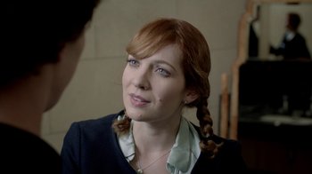 Movie still from “Sherlock” (2010), created by Steven Moffat – A person wearing a suit and tie; Close Up shot, Over the shoulder angle