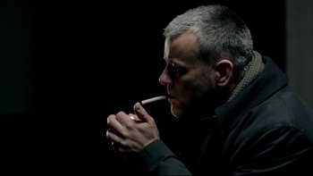 Movie still from “Sherlock” (2010), created by Steven Moffat – A man with a cigarette in his mouth; Close Up shot, Low angle