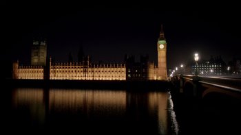 Movie still from “Sherlock” (2010), created by Steven Moffat – A view of big ben from across the river thames at night; Extreme Wide shot, High angle