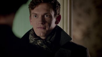 Movie still from “Sherlock” (2010), created by Steven Moffat – A person wearing a coat; Close Up shot, Over the shoulder angle