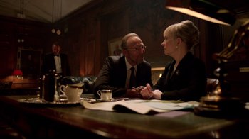 Movie still from “Sherlock” (2010), created by Steven Moffat – A man and a woman sitting at a table talking to each other; Medium shot, Over the shoulder angle