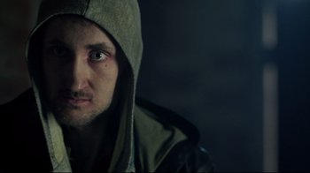 Movie still from “Sherlock” (2010), created by Steven Moffat – A person wearing a hooded jacket; Close Up shot, Over the shoulder angle