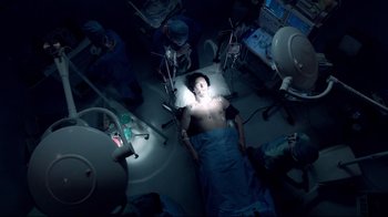 An overhead view of a person in a hospital bed