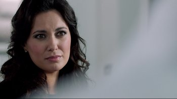 Movie still from “Sherlock” (2010), created by Steven Moffat – A woman's face in a room; Close Up shot, Over the shoulder angle