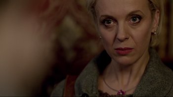 Movie still from “Sherlock” (2010), created by Steven Moffat – A person wearing a necklace; Close Up shot, Over the shoulder angle
