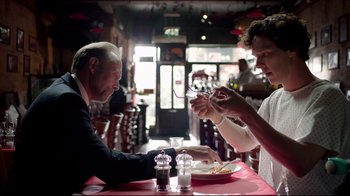Movie still from “Sherlock” (2010), created by Steven Moffat – Two people sitting at a table with a plate of food in front of them; Medium shot, Overhead angle