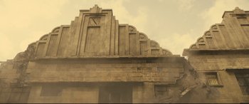 Movie still from “Spectre” (2015), directed by Sam Mendes – An old building with a clock on the side of it; Extreme Wide shot, Low angle