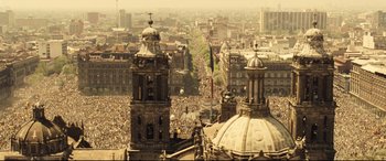 Movie still from “Spectre” (2015), directed by Sam Mendes – An aerial view of a large crowd in a city; Extreme Wide shot, High angle