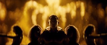 Movie still from “Spectre” (2015), directed by Sam Mendes – A man with his arms around two women; Medium shot, Low angle