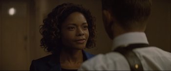 Movie still from “Spectre” (2015), directed by Sam Mendes – A person looking at a person; Close Up shot, Over the shoulder angle