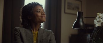 Movie still from “Spectre” (2015), directed by Sam Mendes – A woman sitting in front of a window looking up at the sky; Medium shot, Low angle