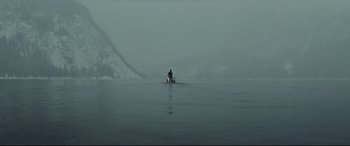 Movie still from “Spectre” (2015), directed by Sam Mendes – A person in a boat on a body of water; Extreme Wide shot, High angle