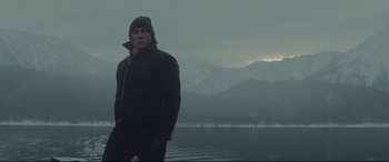 Movie still from “Spectre” (2015), directed by Sam Mendes – A man standing in front of a body of water; Medium shot, Low angle