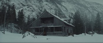 Movie still from “Spectre” (2015), directed by Sam Mendes – An old wooden building in the middle of a snow covered forest; Extreme Wide shot, High angle