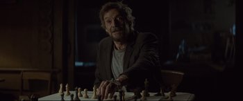 Movie still from “Spectre” (2015), directed by Sam Mendes – A man sitting in front of a chess board; Medium shot, Over the shoulder angle