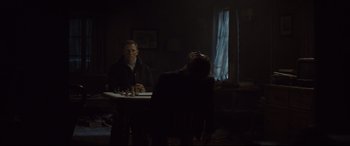 Movie still from “Spectre” (2015), directed by Sam Mendes – A man and a woman sitting at a dinner table; Medium shot, Over the shoulder angle