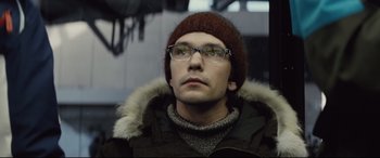 Movie still from “Spectre” (2015), directed by Sam Mendes – A person wearing glasses and a hat; Close Up shot, Low angle