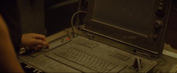 Movie still from “Spectre” (2015), directed by Sam Mendes – A computer keyboard sitting on top of a desk; Extreme Close Up shot, High angle