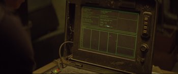 Movie still from “Spectre” (2015), directed by Sam Mendes – An old computer monitor with a green screen on it; Extreme Close Up shot, High angle