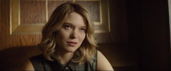 Movie still from “Spectre” (2015), directed by Sam Mendes – A person with blonde hair; Close Up shot, Over the shoulder angle