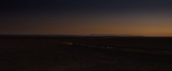 Movie still from “Spectre” (2015), directed by Sam Mendes – A train traveling on a train track in the middle of nowhere at night; Extreme Wide shot, Low angle