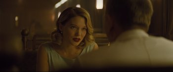 Movie still from “Spectre” (2015), directed by Sam Mendes – A woman sitting in front of a man in front of a mirror; Close Up shot, Over the shoulder angle