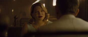Movie still from “Spectre” (2015), directed by Sam Mendes – A woman with blonde hair and red lipstick looking into a mirror; Close Up shot, Over the shoulder angle