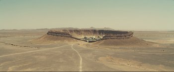 Movie still from “Spectre” (2015), directed by Sam Mendes – An aerial view of an open desert area; Extreme Wide shot, High angle
