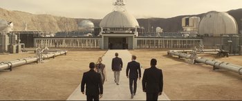 Movie still from “Spectre” (2015), directed by Sam Mendes – A group of people walking down a sidewalk; Extreme Wide shot, Low angle