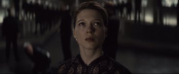 Movie still from “Spectre” (2015), directed by Sam Mendes – A young woman with short brown hair wearing a black dress; Close Up shot, Low angle