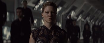 Movie still from “Spectre” (2015), directed by Sam Mendes – A woman in a black and white dress looking to her left; Close Up shot, Low angle