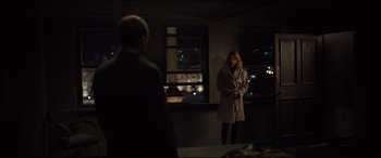 Movie still from “Spectre” (2015), directed by Sam Mendes – A man and a woman standing in front of a window; Wide shot, Over the shoulder angle