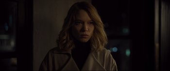 Movie still from “Spectre” (2015), directed by Sam Mendes – A woman with blonde hair wearing a black shirt; Close Up shot, Over the shoulder angle