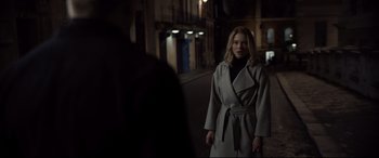 Movie still from “Spectre” (2015), directed by Sam Mendes – A woman wearing a trench coat walking down a street; Medium shot, Over the shoulder angle
