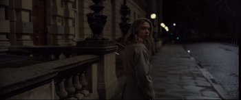 Movie still from “Spectre” (2015), directed by Sam Mendes – A woman standing on the side of a building; Medium shot, Low angle