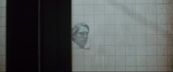Movie still from “Spectre” (2015), directed by Sam Mendes – A portrait of a man hanging on a wall; Close Up shot, Over the shoulder angle