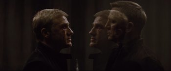 Movie still from “Spectre” (2015), directed by Sam Mendes – A man's face is reflected in a mirror; Close Up shot, Overhead angle