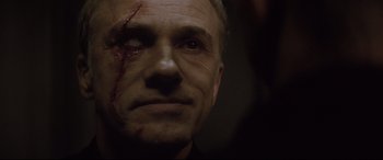 Movie still from “Spectre” (2015), directed by Sam Mendes – A person with a scar on his face; Close Up shot, Over the shoulder angle