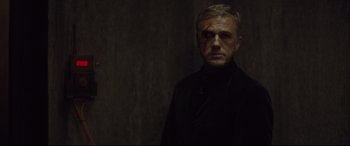 Movie still from “Spectre” (2015), directed by Sam Mendes – A man in a black jacket with a blood on his face; Close Up shot, Over the shoulder angle