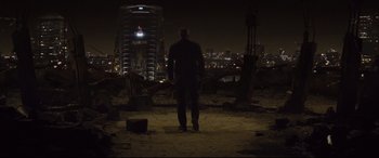 Movie still from “Spectre” (2015), directed by Sam Mendes – A man standing on top of a hill at night; Wide shot, Low angle