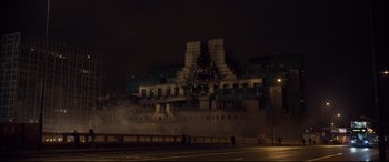 Movie still from “Spectre” (2015), directed by Sam Mendes – A building that has been burned down and is lit up at night; Extreme Wide shot, High angle